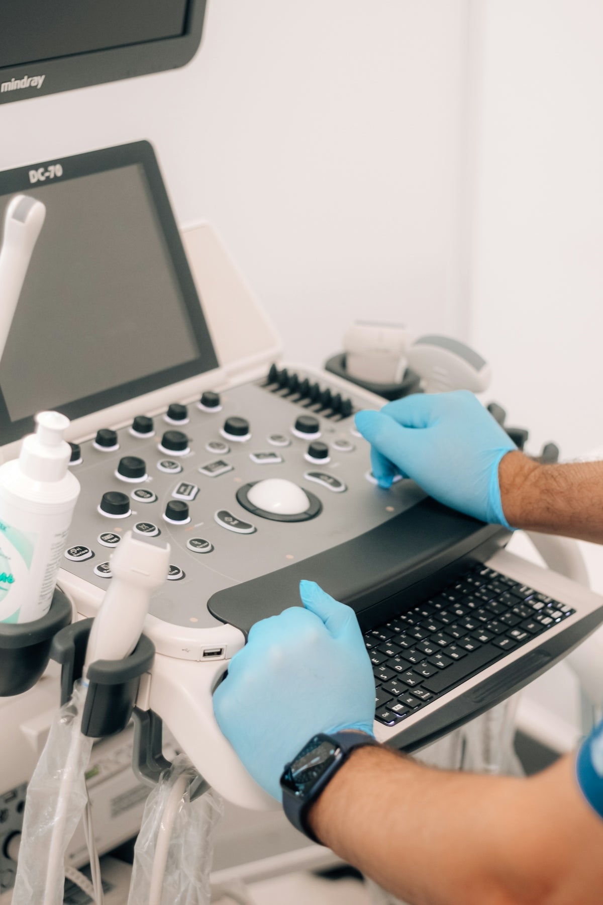 a person in blue gloves is operating a machine
